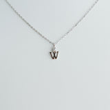 Silver necklace with a 'W' pendant on a light gray background