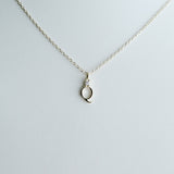 Necklace with a small pendant on a light gray background