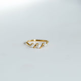 Gold ring with pearls on a light gray background