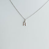 Necklace with a small pendant on a light gray background