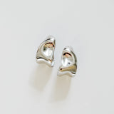 Pair of silver earrings on a light gray background