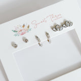 Set of earrings on a branded display card with 'Sweet Threes' branding.