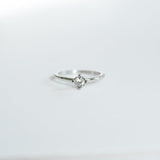 Silver ring with a diamond on a white background